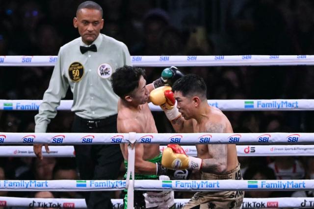 Takuma Inoue (L) fights Kazuto Ioka during their WBC Bantamweight Title Match boxing contest at Tokyo Dome in Tokyo on May 2, 2026. (Photo by Yuichi YAMAZAKI / AFP)