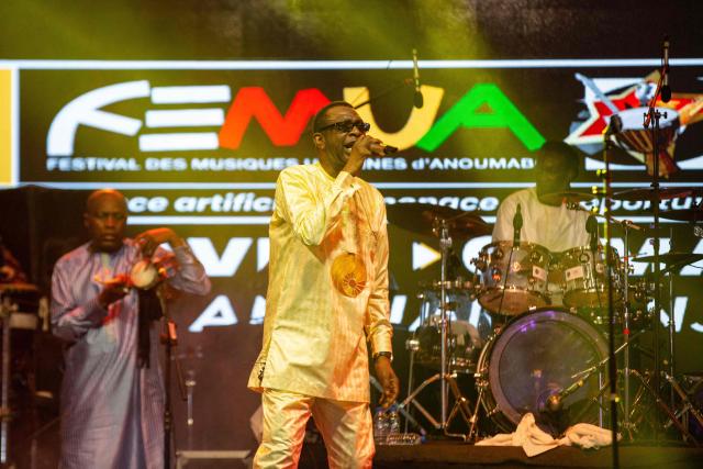 Senegalese singer and artist Youssou N’Dour (C) performs during the 18th Anoumabo Urban Music Festival (FEMUA) in Abidjan on May 1, 2026. (Photo by Chris Boli / AFP)