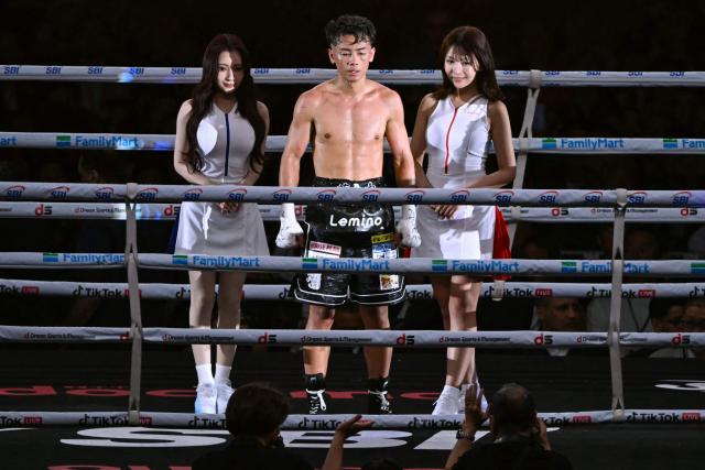 Yoshiki Takei of Japan (C) reacts after defeating DeKang Wang of China in their super bantamweight non-title boxing contest at Tokyo Dome in Tokyo on May 2, 2026. (Photo by Yuichi YAMAZAKI / AFP)