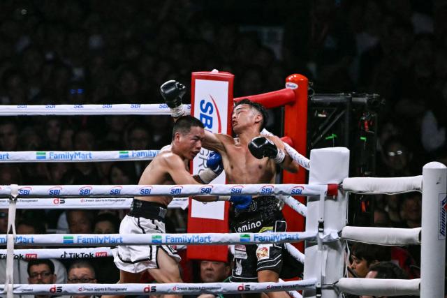 Yoshiki Takei of Japan (R) fights DeKang Wang of China during their super bantamweight non-title boxing contest at Tokyo Dome in Tokyo on May 2, 2026. (Photo by Yuichi YAMAZAKI / AFP)