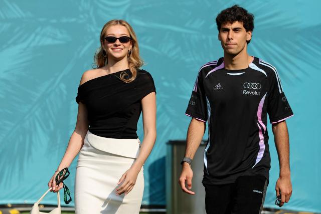 Audi's Brazilian driver Gabriel Bortoleto and his girlfriend Isabella Bernardini arrive for the 2026 Miami Formula One Sprint at Miami International Autodrome in Miami Gardens, Florida, on May 2, 2026. (Photo by CHARLY TRIBALLEAU / AFP)