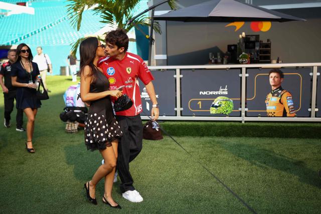 Ferrari's Monegasque driver Charles Leclerc kisses his wife Alexandra Saint Mleux as they arrive for the 2026 Miami Formula One Sprint at Miami International Autodrome in Miami Gardens, Florida, on May 2, 2026. (Photo by CHARLY TRIBALLEAU / AFP)