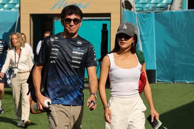 Williams' Thai driver Alexander Albon and Lily Muni He arrive for the 2026 Miami Formula One Sprint at Miami International Autodrome in Miami Gardens, Florida, on May 2, 2026. (Photo by CHARLY TRIBALLEAU / AFP)