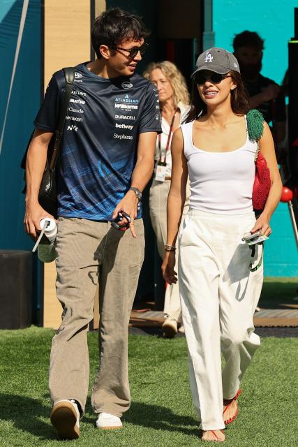 Williams' Thai driver Alexander Albon and Lily Muni He arrive for the 2026 Miami Formula One Sprint at Miami International Autodrome in Miami Gardens, Florida, on May 2, 2026. (Photo by CHARLY TRIBALLEAU / AFP)