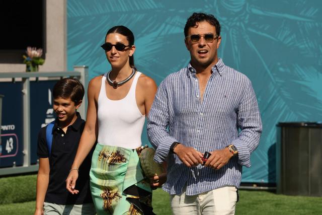 Cadillac's Mexican driver Sergio Perez walks with his wife Carola Martinez and son Sergio as they arrive for 2026 Miami Formula One Sprint at Miami International Autodrome in Miami Gardens, Florida, on May 2, 2026. (Photo by CHARLY TRIBALLEAU / AFP)