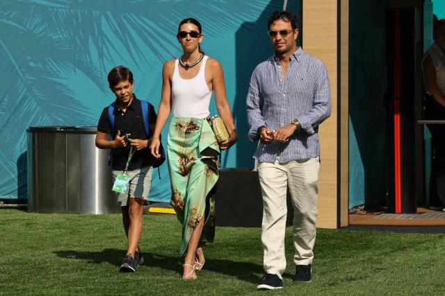 Cadillac's Mexican driver Sergio Perez walks with his wife Carola Martinez and son Sergio as they arrive for 2026 Miami Formula One Sprint at Miami International Autodrome in Miami Gardens, Florida, on May 2, 2026. (Photo by CHARLY TRIBALLEAU / AFP)