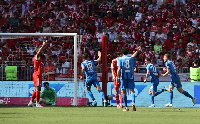 Heidenheim's Georgian forward #11 Budu Zivzivadze (2R) celebrates scoring the opening goal during the German first division Bundesliga football match between FC Bayern Munich and Heidenheim in Munich on May 2, 2026. (Photo by Alexandra BEIER / AFP) / DFL REGULATIONS PROHIBIT ANY USE OF PHOTOGRAPHS AS IMAGE SEQUENCES AND/OR QUASI-VIDEO