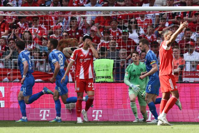 Heidenheim's Georgian forward #11 Budu Zivzivadze (L) celebrates scoring the opening goal during the German first division Bundesliga football match between FC Bayern Munich and Heidenheim in Munich on May 2, 2026. (Photo by Alexandra BEIER / AFP) / DFL REGULATIONS PROHIBIT ANY USE OF PHOTOGRAPHS AS IMAGE SEQUENCES AND/OR QUASI-VIDEO