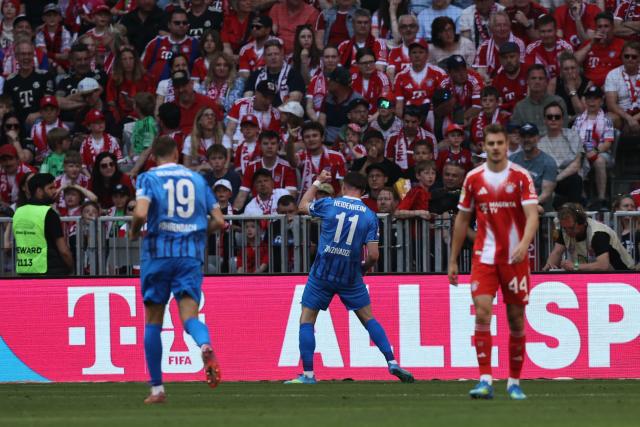 Heidenheim's Georgian forward #11 Budu Zivzivadze (C) celebrates scoring the opening goal during the German first division Bundesliga football match between FC Bayern Munich and Heidenheim in Munich on May 2, 2026. (Photo by Alexandra BEIER / AFP) / DFL REGULATIONS PROHIBIT ANY USE OF PHOTOGRAPHS AS IMAGE SEQUENCES AND/OR QUASI-VIDEO