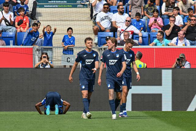 Hoffenheim's Ivorian midfielder #29 Bazoumana Toure (Bottom L) celebrates his 2-1 during the German first division Bundesliga football match between TSG Hoffenheim and VfB Stuttgart in Sinsheim, on May 2, 2026. (Photo by THOMAS KIENZLE / AFP) / DFL REGULATIONS PROHIBIT ANY USE OF PHOTOGRAPHS AS IMAGE SEQUENCES AND/OR QUASI-VIDEO