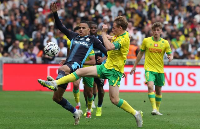 Nantes' French defender #03 Nicolas Cozza (R) fights for the ball with Marseille's English forward #10 Mason Greenwood during the French L1 football match between FC Nantes and Olympique de Marseille at the Stade de la Beaujoire–Louis Fonteneau in Nantes, western France on May 2, 2026. (Photo by Fred TANNEAU / AFP)
