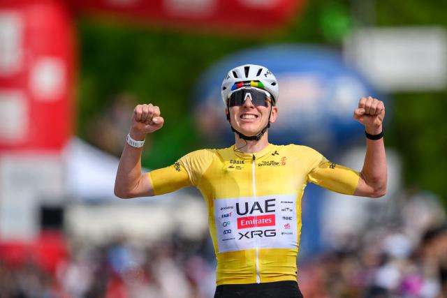 UAE Team Emirates-XRG's Slovenian rider Tadej Pogacar celebrates as he crosses the finish line wining the fourth stage of the Tour of Romandie UCI cycling World tour, 149.6 km from Broc and to Charmey, in Charmey, Switzerland, on May, 2, 2026. (Photo by Fabrice COFFRINI / AFP)
