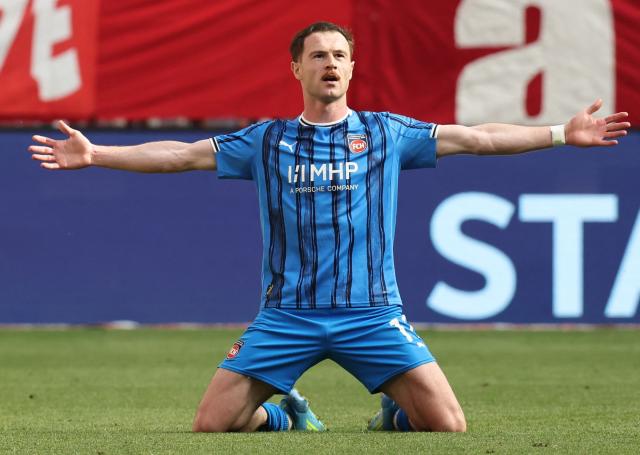 Heidenheim's Georgian forward #11 Budu Zivzivadze celebrates scoring his team's third goal  during the German first division Bundesliga football match between FC Bayern Munich and Heidenheim in Munich on May 2, 2026. (Photo by Alexandra BEIER / AFP) / DFL REGULATIONS PROHIBIT ANY USE OF PHOTOGRAPHS AS IMAGE SEQUENCES AND/OR QUASI-VIDEO