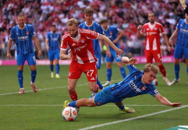 Bayern Munich's Austrian midfielder #27 Konrad Laimer (L) and Heidenheim's German defender #26 Hennes Behrens vie for the ball during the German first division Bundesliga football match between FC Bayern Munich and Heidenheim in Munich on May 2, 2026. (Photo by Alexandra BEIER / AFP) / DFL REGULATIONS PROHIBIT ANY USE OF PHOTOGRAPHS AS IMAGE SEQUENCES AND/OR QUASI-VIDEO