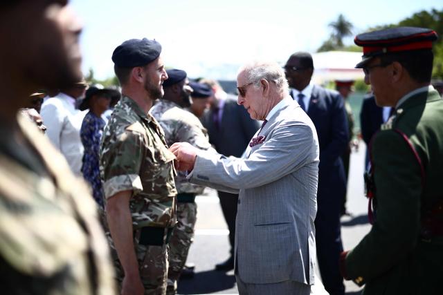Britain's King Charles III presents an Operational Service Medal to members of the military at the Great Bay Coast Guard Station in St. David's, Bermuda, on May 2, 2026. King Charles III is in Bermuda for his first visit to a British Overseas Territory as Sovereign. (Photo by Henry NICHOLLS / AFP)