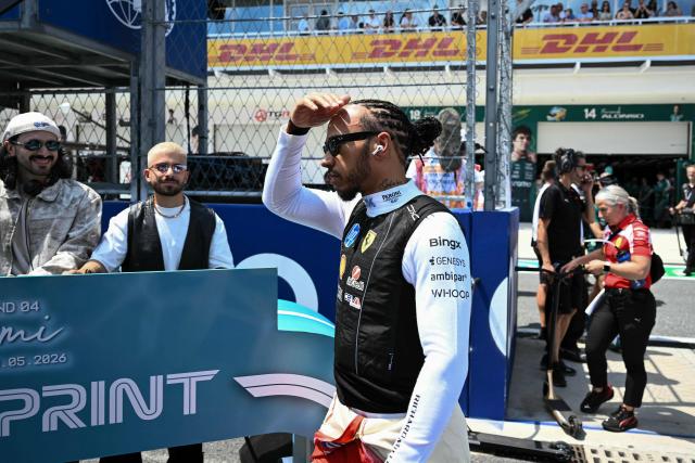 Ferrari's British driver Lewis Hamilton arrives at the starting grid for the 2026 Miami Formula One Sprint at Miami International Autodrome in Miami Gardens, Florida, on May 2, 2026. (Photo by CHANDAN KHANNA / AFP)