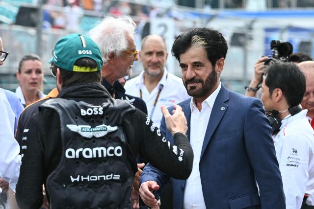 FIA President Mohammed Ben Sulayem (R) speaks with Aston Martin's Spanish driver Fernando Alonso on the starting grid prior to the start of the 2026 Miami Formula One Sprint at Miami International Autodrome in Miami Gardens, Florida, on May 2, 2026. (Photo by CHANDAN KHANNA / AFP)
