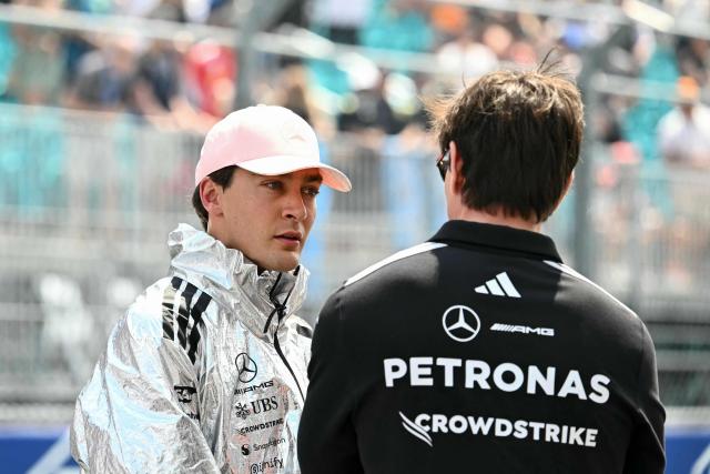 (L/R) Mercedes' British driver George Russell speaks with Mercedes' Austrian team principal and CEO Toto Wolff on the starting grid prior to the start of the 2026 Miami Formula One Sprint at Miami International Autodrome in Miami Gardens, Florida, on May 2, 2026. (Photo by CHANDAN KHANNA / AFP)
