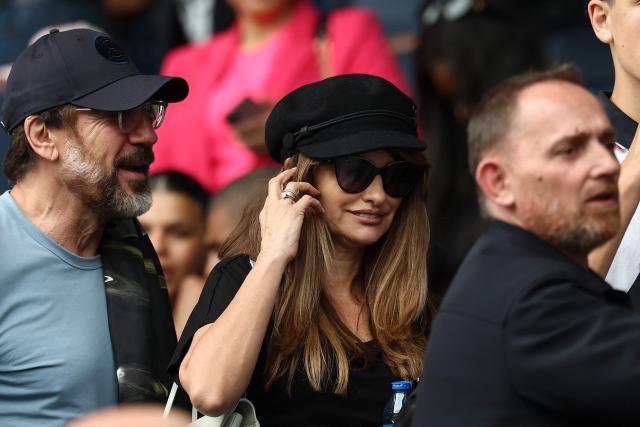 Spanish actor Javier Bardem (L) and Spanish actress Penelope Cruz (C) look on in the stands during the French L1 football match between Paris Saint-Germain (PSG) and FC Lorient at Parc des Princes stadium in Paris on May 2, 2026. (Photo by FRANCK FIFE / AFP)