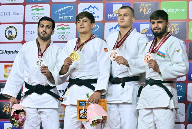 (From L) Silver medallist Russia's Karen Galstian, gold medallist Tajikistan's Muhiddin Asadulloev and bronze medallists Russia's Danil Lavrentiev and Azerbaijan's Rashid Mammadaliyev pose on the podium after their men's -73kg category at the Dushanbe Grand Slam judo tournament in Dushanbe on May 2, 2026. (Photo by AFP)