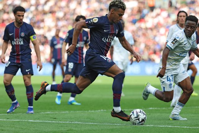 Paris Saint-Germain's French forward #14 Desire Doue (C) controls the ball next to Lorient's Burkinabe midfielder #43 Arsene Kouassi (R) during the French L1 football match between Paris Saint-Germain (PSG) and FC Lorient at Parc des Princes stadium in Paris on May 2, 2026. (Photo by FRANCK FIFE / AFP)