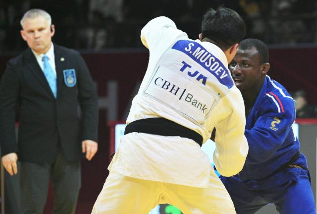 Tajikistan's Suatullo Musoev (C) and France's Alpha Oumar Djalo (R) fight during their men's -81kg category bronze medal match at the Dushanbe Grand Slam judo tournament in Dushanbe on May 2, 2026. (Photo by AFP)