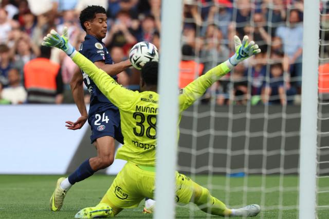 Paris Saint-Germain's French midfielder #24 Senny Mayulu (L) tries to score in front of Lorient's Swiss goalkeeper #38 Yvon Mvogo during the French L1 football match between Paris Saint-Germain (PSG) and FC Lorient at Parc des Princes stadium in Paris on May 2, 2026. (Photo by FRANCK FIFE / AFP)