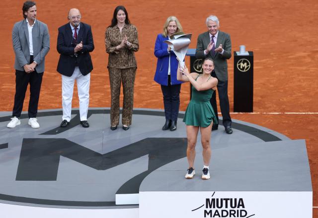 Ukraine's Marta Kostyuk celebrates with her trophy after beating Russia's Mirra Andreeva during the 2026 WTA Tour Madrid Open tennis tournament final singles match at the Caja Magica in Madrid, on May 2, 2026. (Photo by Thomas COEX / AFP)