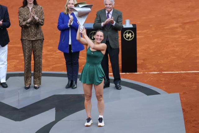 Ukraine's Marta Kostyuk celebrates with her trophy after beating Russia's Mirra Andreeva during the 2026 WTA Tour Madrid Open tennis tournament final singles match at the Caja Magica in Madrid, on May 2, 2026. (Photo by Thomas COEX / AFP)