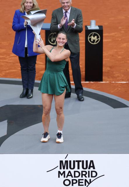 Ukraine's Marta Kostyuk celebrates with her trophy after beating Russia's Mirra Andreeva during the 2026 WTA Tour Madrid Open tennis tournament final singles match at the Caja Magica in Madrid, on May 2, 2026. (Photo by Thomas COEX / AFP)