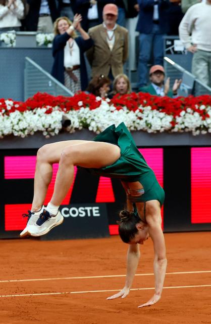 Ukraine's Marta Kostyuk does a backflip as she celebrates beating Russia's Mirra Andreeva during the 2026 WTA Tour Madrid Open tennis tournament final singles match at the Caja Magica in Madrid, on May 2, 2026. (Photo by Oscar DEL POZO / AFP)