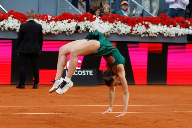 Ukraine's Marta Kostyuk does a backflip as she celebrates beating Russia's Mirra Andreeva during the 2026 WTA Tour Madrid Open tennis tournament final singles match at the Caja Magica in Madrid, on May 2, 2026. (Photo by Oscar DEL POZO / AFP)