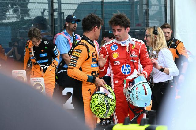 Race winner McLaren's British driver Lando Norris (C) speaks with 2nd place  finisher Ferrari's Monegasque driver Charles Leclerc (R) after the 2026 Miami Formula One Sprint at Miami International Autodrome in Miami Gardens, Florida, on May 2, 2026. (Photo by CHANDAN KHANNA / AFP)