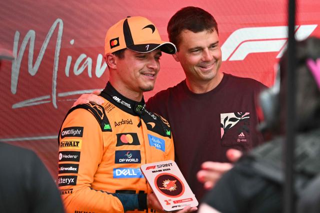 McLaren's British driver Lando Norris (L) stands next to US astronaut Reid Wiseman after winning the 2026 Miami Formula One Sprint at Miami International Autodrome in Miami Gardens, Florida, on May 2, 2026. (Photo by CHANDAN KHANNA / AFP)