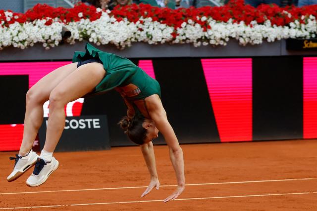 Ukraine's Marta Kostyuk does a backflip as she celebrates beating Russia's Mirra Andreeva during the 2026 WTA Tour Madrid Open tennis tournament final singles match at the Caja Magica in Madrid, on May 2, 2026. (Photo by Oscar DEL POZO / AFP)