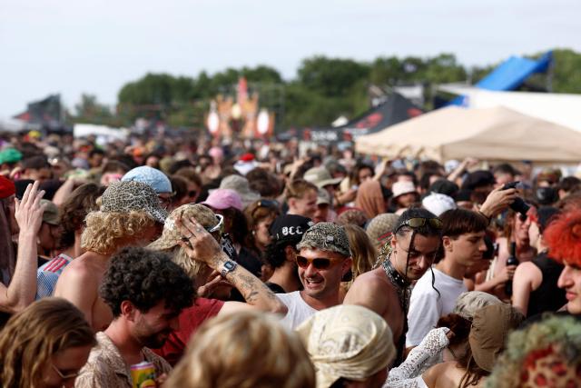 Revellers take part in a "teknival" rave party at a military site in Cornusse, near Bourges, central France on May 2, 2026. Around 20,000 partygoers gathered on May 1 for an illegal rave at a military site in France, defying warnings about the risk of unexploded ordnance and possible blasts. The rave near the town of Bourges in central France kicked off on May 1 and organisers expect as many as 30,000 people from France and neighbouring countries to arrive at the peak of the event this weekend. (Photo by Kenzo TRIBOUILLARD / AFP)