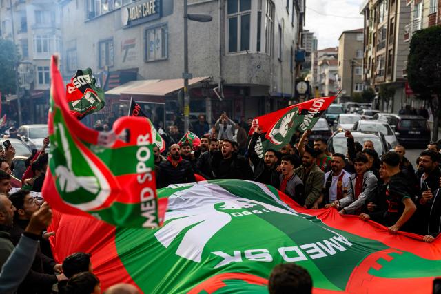 Amedspor fans celebrate their team's promotion to the Turkcell Super League, in Istanbul, on May 2, 2026. Amedspor, a club from Diyarbakir, the "capital" of Turkey's predominantly Kurdish southeast, was promoted to the Turkcell Super League after their 3-3  against Igdirspor. (Photo by Yasin AKGUL / AFP)