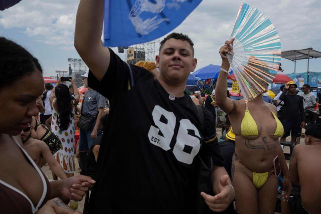 Fans gather near the stage ahead of Colombian singer Shakira's concert, eager to secure a close view for the performance, at Copacabana Beach in Rio de Janeiro, Brazil on May 02, 2026. (Photo by Pablo PORCIUNCULA / AFP)