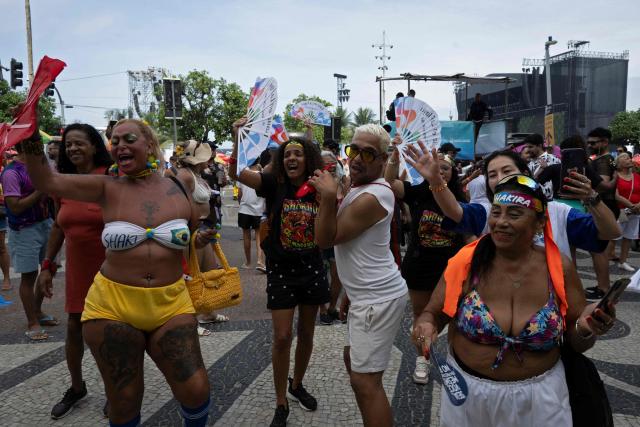 Fans gather near the stage ahead of Colombian singer Shakira's concert, eager to secure a close view for the performance, at Copacabana Beach in Rio de Janeiro, Brazil on May 02, 2026. (Photo by Pablo PORCIUNCULA / AFP)