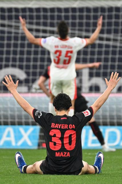 Bayer Leverkusen's Algerian midfielder #30 Ibrahim Maza (front) and Leipzig's German defender #35 Max Finkgrafe reacts after the 3-0 goal during the German first division Bundesliga football match between Bayer 04 Leverkusen and RB Leipzig in Leverkusen, western Germany, on May 2, 2026. (Photo by UWE KRAFT / AFP) / DFL REGULATIONS PROHIBIT ANY USE OF PHOTOGRAPHS AS IMAGE SEQUENCES AND/OR QUASI-VIDEO  ALTERNATIVE CROP
