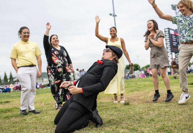 People dance before the 152nd running of the Kentucky Derby at Churchill Downs in Louisville, Kentucky, on May 2, 2026. (Photo by Leandro Lozada / AFP)