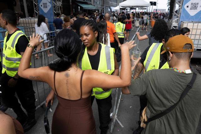 Security personnel check fans as they access streets leading to Copacabana beach ahead of the concert of Colombioan singer Shakira in Rio de Janeiro, Brazil on May 02, 2026. (Photo by Pablo PORCIUNCULA / AFP)