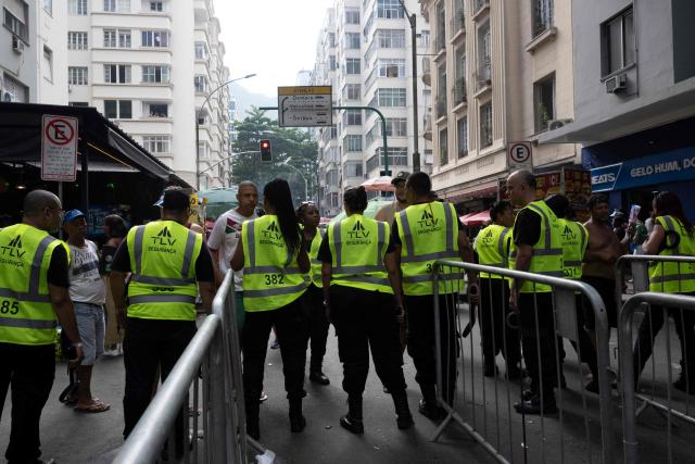 Security personnel check fans as they access streets leading to Copacabana beach ahead of the concert of Colombioan singer Shakira in Rio de Janeiro, Brazil on May 02, 2026. (Photo by Pablo PORCIUNCULA / AFP)