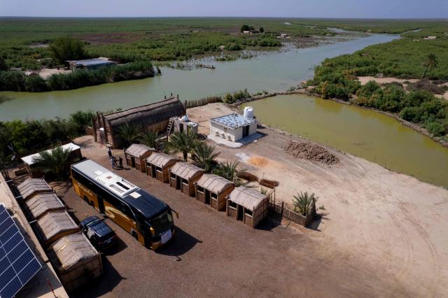 An aerial photograph shows the al-Chibayish Marches following recent rains, near the town of Al-Chibayish close to the Euphrates River in Dhi Qar governorate, southern Iraq on May 2, 2026. The Al-Chibayish Marshes are part of the larger Mesopotamian Marshes system between the Tigris and Euphrates rivers, and the largest wetlands in Southwest Asia. They are important wetlands for migratory birds, endemic birds, fish, and buffalo breeding and also home to the March Arabs. (Photo by Assad NIYAZI / AFP)