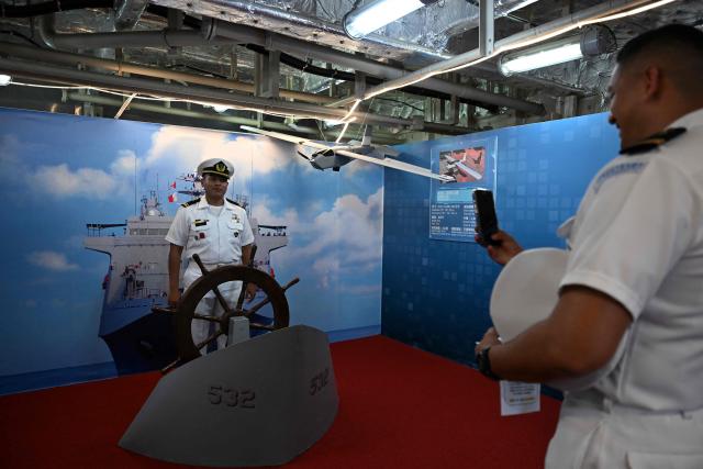 Members of the Guatemalan navy take photos onboard one of three Taiwanese Navy warships that arrived at Puerto Quetzal, Guatemala on May 2, 2026, as part of a naval squadron. The three vessels -- described as being on a training mission -- powered into Puerto Quetzal, a port town on Guatemala's Pacific coast, in a visit "to strengthen the ties of friendship," Guatemalan officials and Taiwanese diplomats said. (Photo by Johan ORDONEZ / AFP)