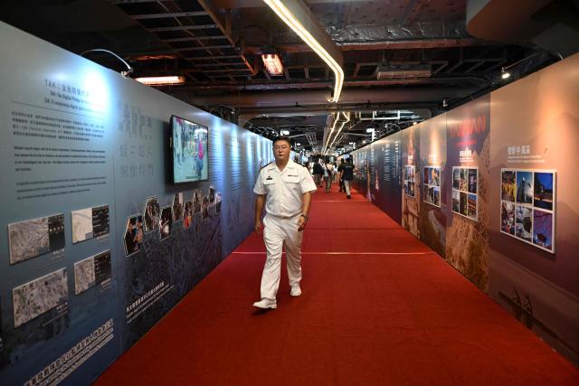 A member of the Taiwanese navy walks onboard one of three Taiwanese Navy warships after their arrival at Puerto Quetzal, Guatemala on May 2, 2026, as part of a naval squadron. The three vessels -- described as being on a training mission -- powered into Puerto Quetzal, a port town on Guatemala's Pacific coast, in a visit "to strengthen the ties of friendship," Guatemalan officials and Taiwanese diplomats said. (Photo by Johan ORDONEZ / AFP)
