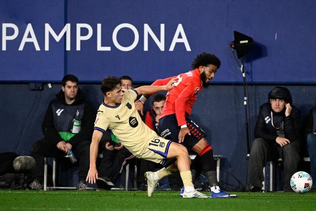 Barcelona's Spanish midfielder #16 Fermin Lopez and Osasuna's French defender #19 Valentin Rosier fight for the ball during the Spanish league football match between CA Osasuna and FC Barcelona at El Sadar Stadium in Pamplona on May 2, 2026. (Photo by ANDER GILLENEA / AFP)