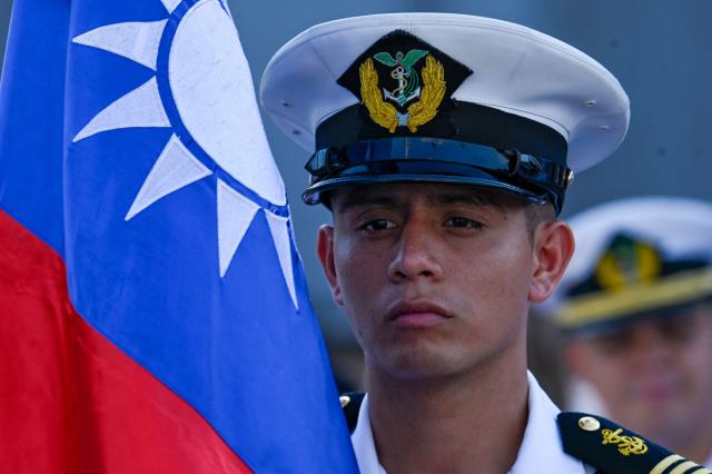 A member of the Guatemalan navy takes part in a ceremony after three Taiwanese Navy warships arrived at Puerto Quetzal, Guatemala on May 2, 2026, as part of a naval squadron. The three vessels -- described as being on a training mission -- powered into Puerto Quetzal, a port town on Guatemala's Pacific coast, in a visit "to strengthen the ties of friendship," Guatemalan officials and Taiwanese diplomats said. (Photo by Johan ORDONEZ / AFP)