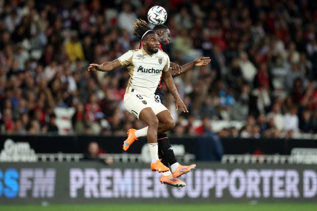 Lens' French forward #09 Allan Saint-Maximin (L) fights for the ball with Nice's Senegalese defender #33 Antoine Mendy during the French L1 football match between OGC Nice and RC Lens at the Allianz Riviera Stadium in Nice on May 2, 2026. (Photo by Valery HACHE / AFP)
