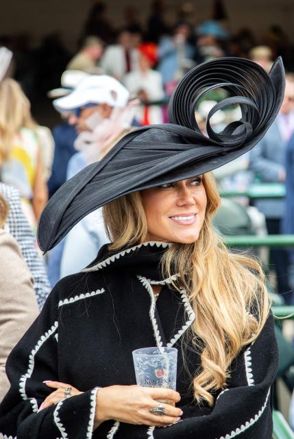 A woman attends the 152nd running of the Kentucky Derby at Churchill Downs in Louisville, Kentucky, on May 2, 2026. (Photo by Leandro Lozada / AFP)
